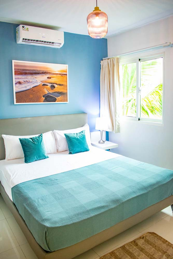 Bed in a penthouse bedroom at Beach Apartamentos in Playa Palmera